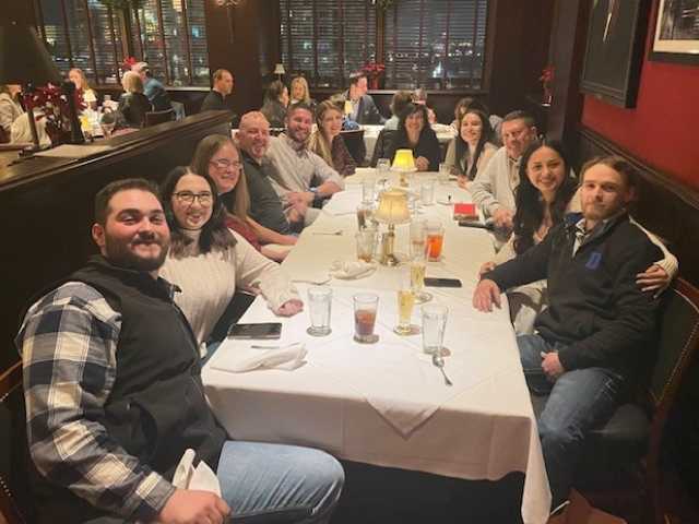 Group of friends enjoying dinner together at a restaurant.