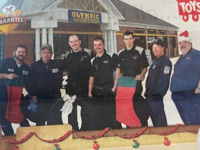 Group photo of six men in sportswear outside a building.